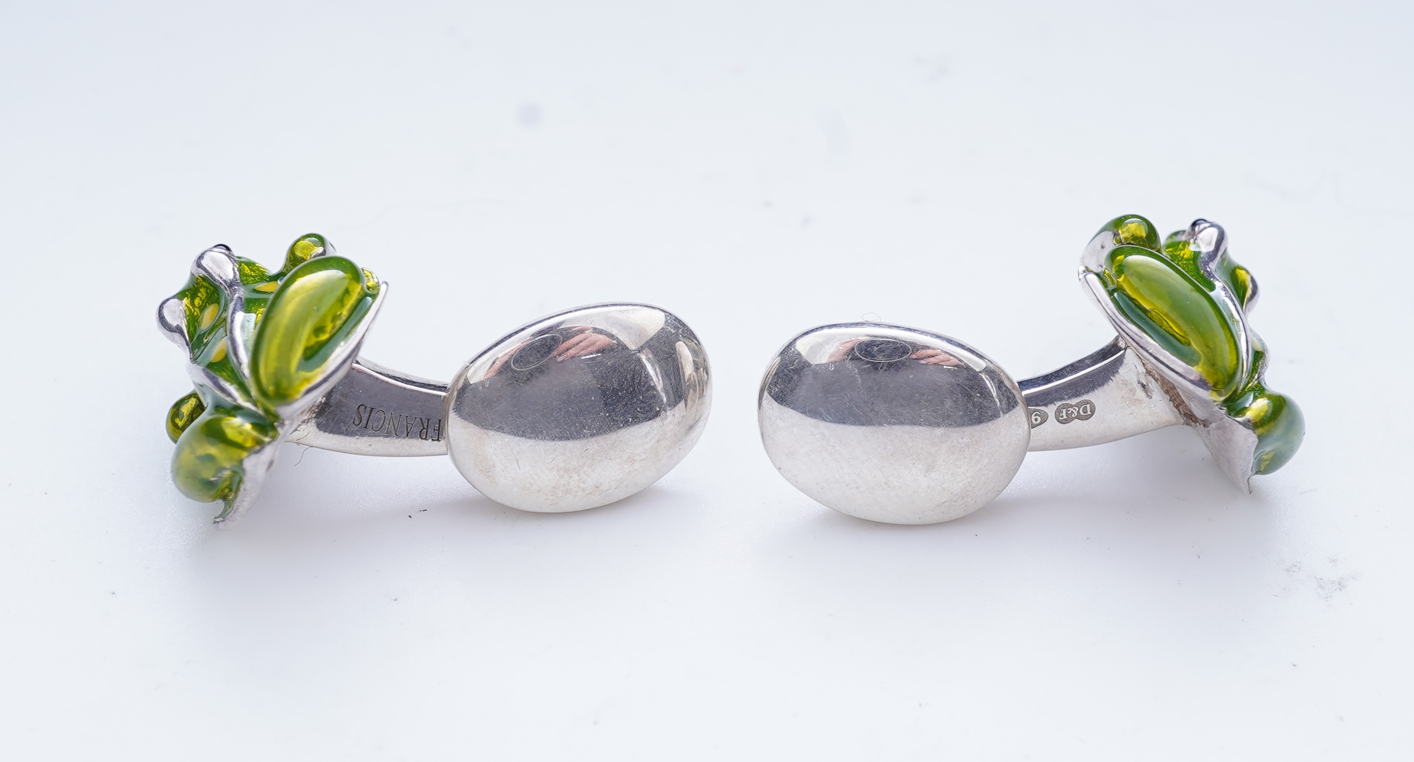 A modern pair of silver and polychrome enamel set oval cufflinks, 18mm.